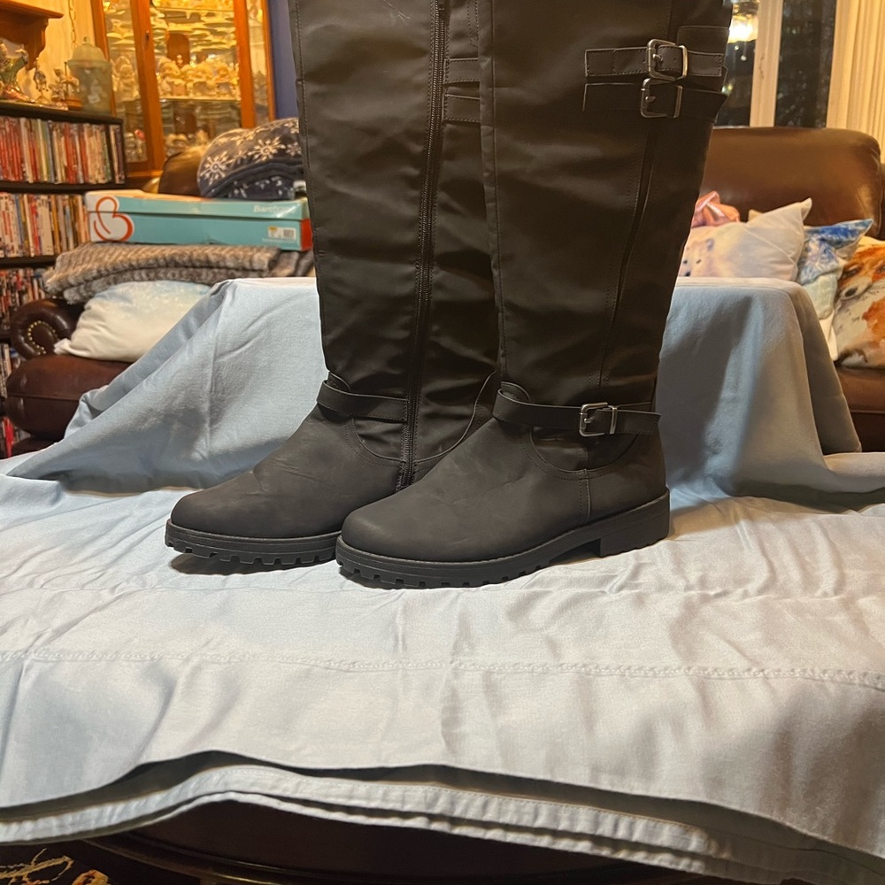 Knee-high black boots with a buckle silver tone zip on the inside